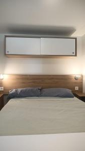 a bedroom with a bed with a wooden headboard at Casetta sul mare in Lido di Classe