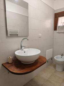 a bathroom with a sink and a toilet at Salento Corte 900 Neviano in Neviano
