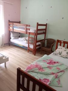a bedroom with two bunk beds and two chairs at Padina-Kovacica in Padina +11 photos