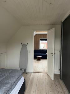 a bedroom with a bed and a living room at Lejlighed med højt til loftet in Herning
