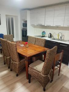 a kitchen with a wooden table and some chairs at Padina-Kovacica in Padina