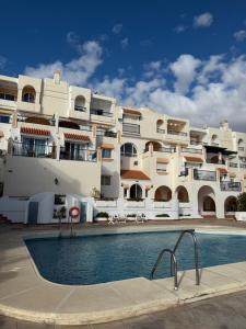 a building with a swimming pool in front of a building at Bahía Vista in San José