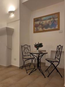 a dining room with a table and two chairs at Salento Corte 900 Neviano in Neviano +14 photos