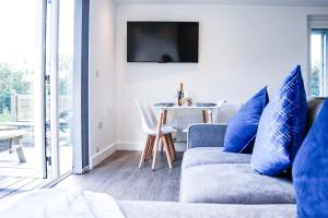 a living room with a couch and a table at Kingfisher in Pembrokeshire