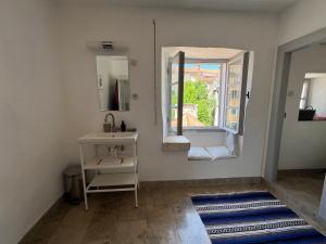 a bathroom with a sink and a window at Light filled spacious penthouse in Šibenik city centre in Šibenik +27 photos