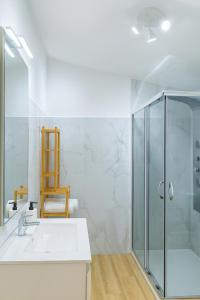 a bathroom with a sink and a glass shower at La Grotta Sardegna 4 Bedrooms in Urzulei +22 photos