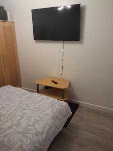 a bedroom with a bed and a television on the wall at Cullen Sqaure in South Ockendon
