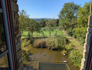 a window view of a field from a house at Saisonnée in Centrès