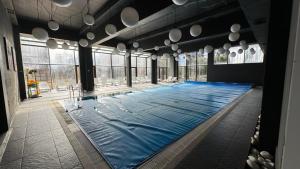 a large swimming pool in a large room with windows at ТРИ ПЛАНИНИ ап113 in Razlog