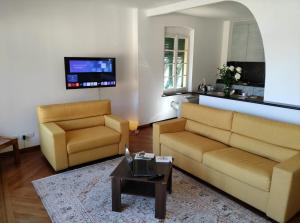 a living room with a couch and a chair at Appartamento Piazzetta Portofino (010044-LT-0030) in Portofino