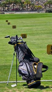 a pile of golf bags sitting on the grass at New Balcon Amadores Best Teide View Apartment Puerto Rico in Mogán