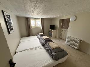 a bedroom with two beds and a television in it at Maison bord de mer - 11 personnes in La Baule