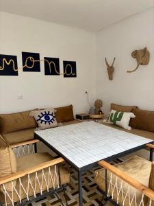 a living room with a table and a couch at Riad MONA Marrakech Kasbah Médina in Marrakech +38 photos