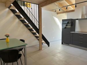 a kitchen with a dining table and a staircase at Guest House 6646 in Contra