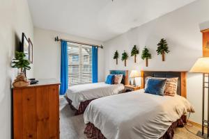a bedroom with two beds and a window at Cozy Breck Condo - Walk to Main St & Lifts - Hot Tub in Breckenridge