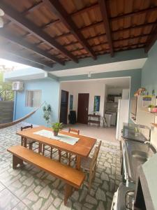 a dining room with a table and a kitchen at Cantinho da amizade in Florianópolis