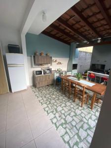 a kitchen with a table and a kitchen with a counter at Cantinho da amizade in Florianópolis +6 photos
