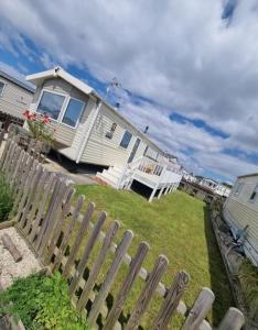 a house with a fence in front of it at 158 Unity Beach Brean 4 birth No pets sorry in Berrow
