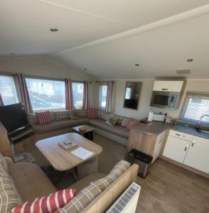 a living room with a couch and a table at 158 Unity Beach Brean 4 birth No pets sorry in Berrow +7 photos