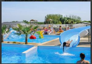 a group of people in a pool at a water park at Mobilhome Vendée Océan in Brem-sur-Mer