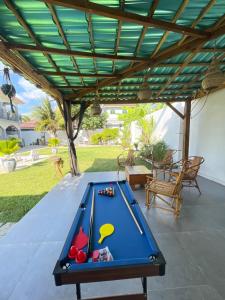 a pool table under awning on a patio at HalmaHome in Chukwani