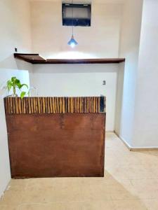 a large wooden garage door with a plant on top at Amanai Tulum-Private Jacuzzi Studio in Tulum