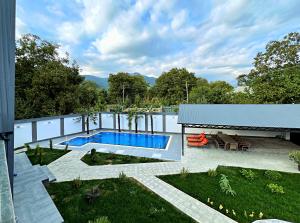 a backyard with a swimming pool and a patio at Qafqaz Palm A-Frame Retreat in Gabala +66 photos