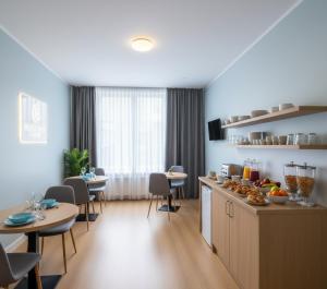 a kitchen with two tables and chairs and a counter at Rüya apart Arsuz in Arsuz +13 photos