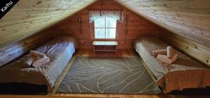 una camera con 2 letti in una baita di tronchi di Quiet Lakeside Forest Escape a Virasoja