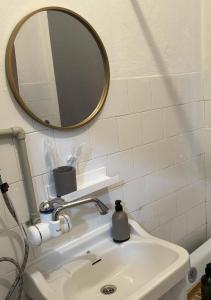 a bathroom sink with a mirror on the wall at Timeless Apartment in Delčevo