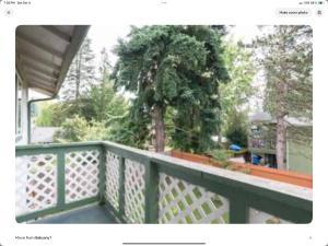 a balcony with a green fence and a tree at Contemporary Marine 2bed 1bath apartment in Kent in Kent