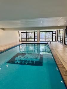 ein großes Schwimmbecken mit blauem Wasser in einem Gebäude in der Unterkunft Opulent Heights - Katherine Quay Sandton in Johannesburg