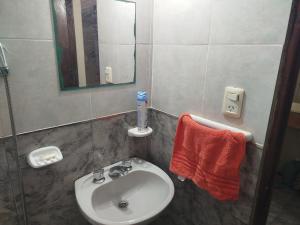 ein Badezimmer mit Waschbecken und Spiegel in der Unterkunft Departamento Manna in Alta Gracia + 6 Fotos