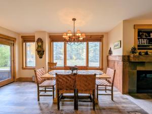 a dining room with a table and chairs and a fireplace at Springs 8803 by SummitCove Lodging in Colorado in Keystone +80 photos