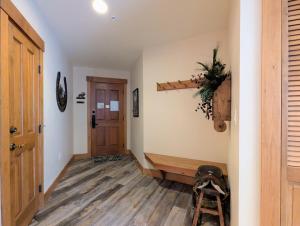 a hallway with a wooden floor and a ladder at Springs 8803 by SummitCove Lodging in Colorado in Keystone