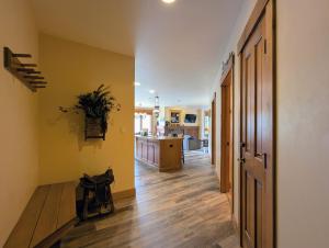 a hallway leading to a kitchen with yellow walls at Springs 8803 by SummitCove Lodging in Colorado in Keystone