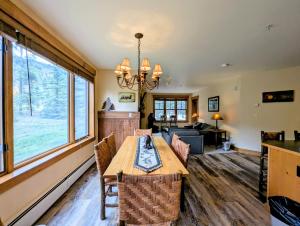 a living room with a wooden table and chairs at Springs 8803 by SummitCove Lodging in Colorado in Keystone