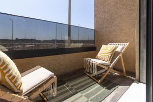 two chairs on a balcony with a view at Fun and Sun - Appartement de luxe - Dahomey Beach - Bouznika in Bouznika
