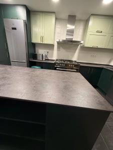 a kitchen with a counter top and a refrigerator at Petit House Madrid Chinatown in Madrid +22 photos