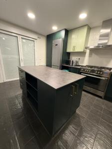 a kitchen with a black island in the middle at Petit House Madrid Chinatown in Madrid