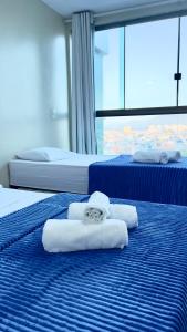 Ένα ή περισσότερα κρεβάτια σε δωμάτιο στο LOFT ORLA PRAIA GRANDE até 5 pessoas