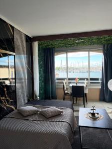 a hotel room with two beds and a view of the water at L'Essentiel in Cap d'Agde
