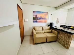 a living room with a couch and a table at Residencial Leste Universitário in Goiânia