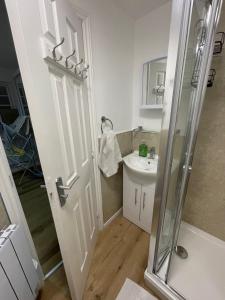 a bathroom with a shower and a sink at Woodlands in Wythenshawe