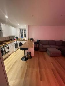 a living room with a couch and a table at Woodlands in Wythenshawe