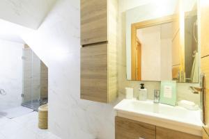 a bathroom with a sink and a mirror at Charm and Calm - Superbe appartement de luxe - Dahomy Beach - Bahia Beach in Bouznika +94 photos