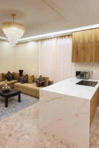a kitchen and living room with a marble counter top at Soho elegance near beach & center 2 bedrooms terrasse in Essaouira