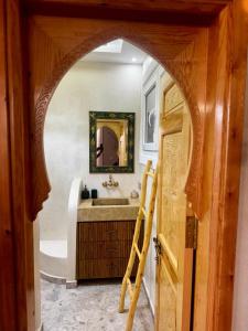 an archway leading into a bathroom with a sink at Soho elegance near beach & center 2 bedrooms terrasse in Essaouira