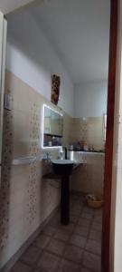 a bathroom with a sink and a mirror on the wall at Quinta RASPANDO in La Reja