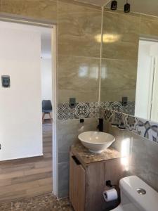 a bathroom with a sink and a toilet at Casa SaasNá, Departamento B, C y D in Cedro +57 photos